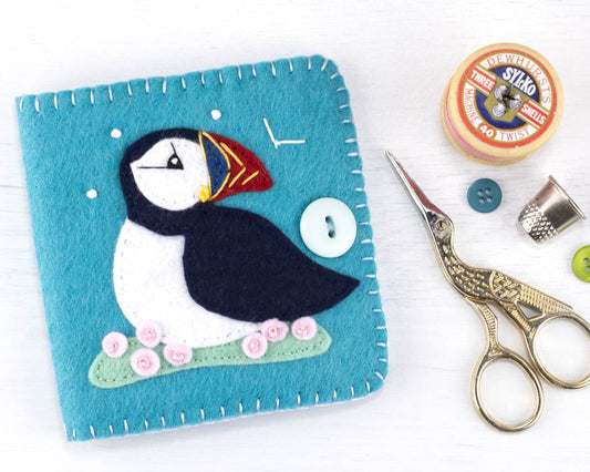 The finished puffin needlebook with stork scissors, thimble, buttons and a vintage cotton reel