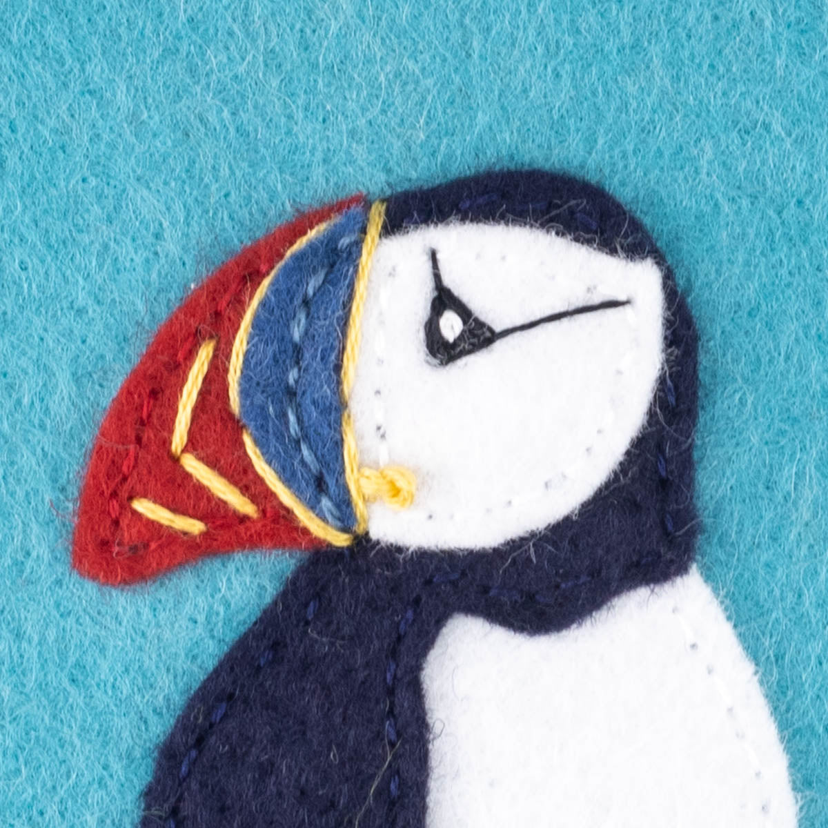 Close up of the puffin's face with the eye and beak markings completed