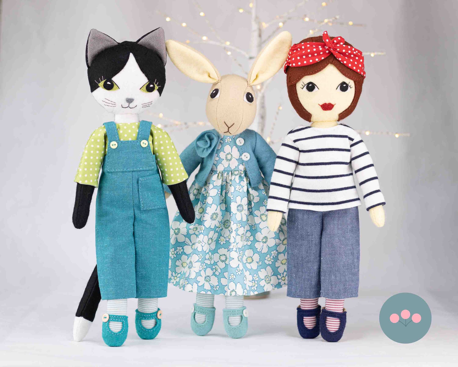 Tilly with Puffin the cat and Tabitha Rabbit, standing together with fairy lights in the background.