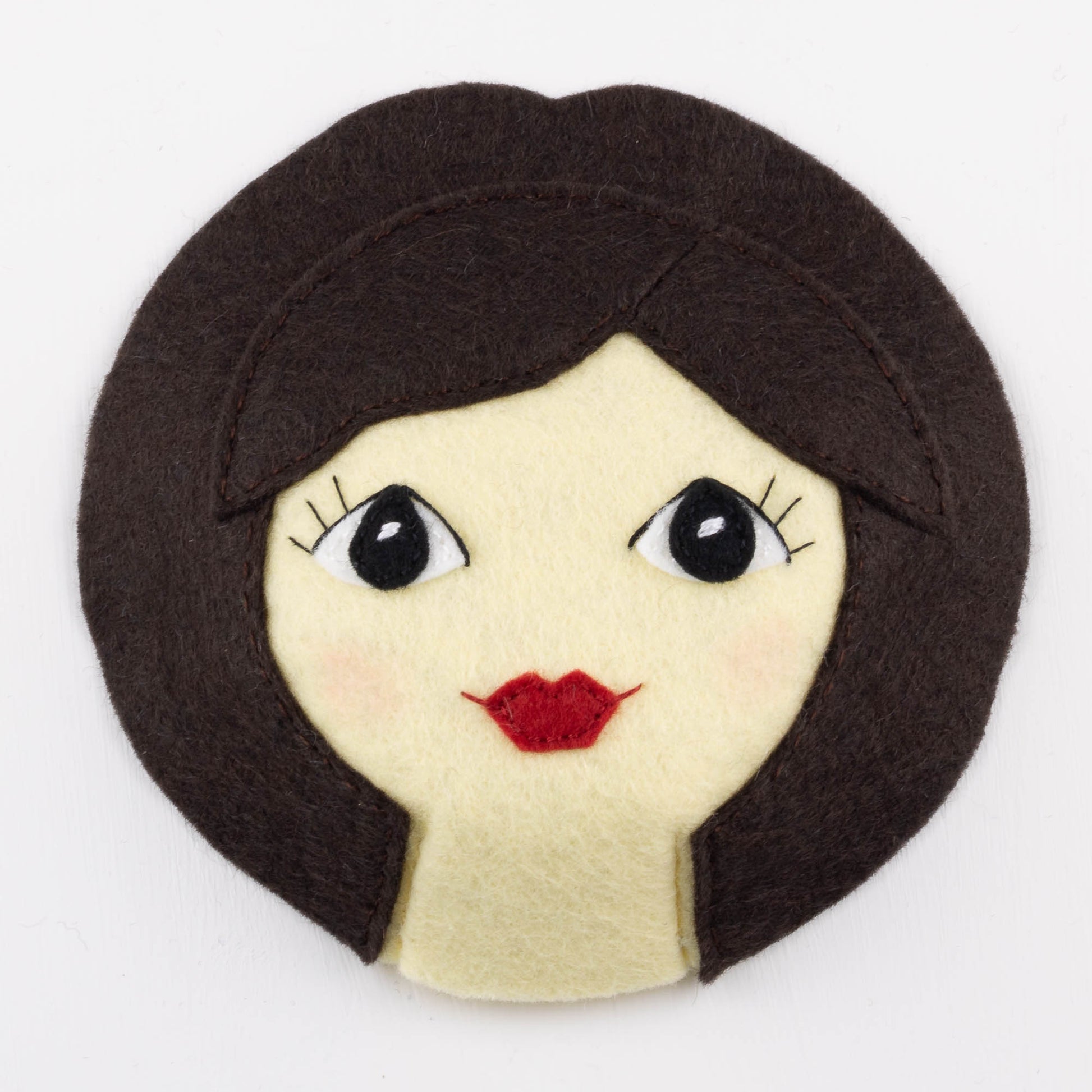 Example photo from the pattern, showing the eyes and mouth appliqued and embroidered on the face